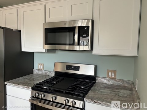 A modern kitchen with a black stove top oven and a black microwave above it.