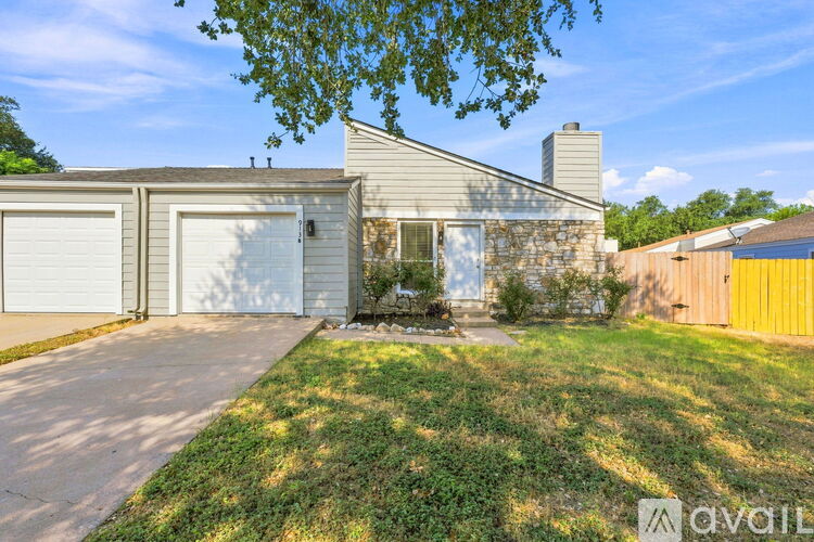 A house with a garage and a driveway is for sale.