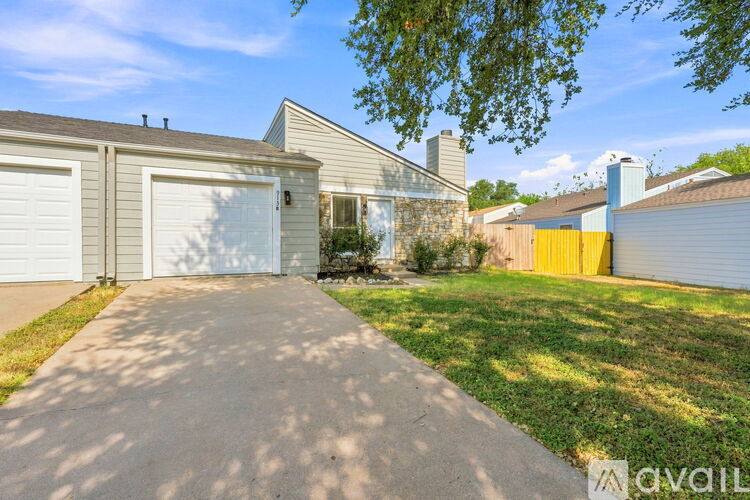A house with a driveway leading to a garage.