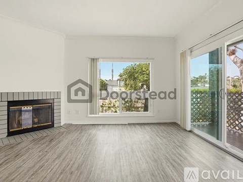 A spacious living room with a fireplace and sliding glass doors.