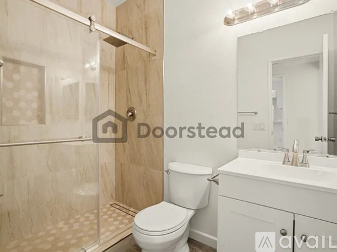 A white toilet in a bathroom with a glass shower door.