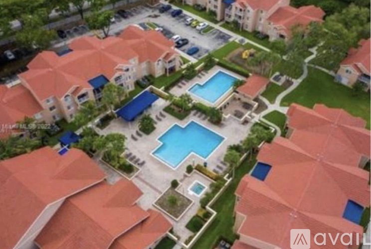 A bird's eye view of a housing complex with a swimming pool.