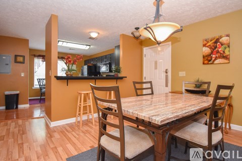 A kitchen with a table and chairs in the foreground.