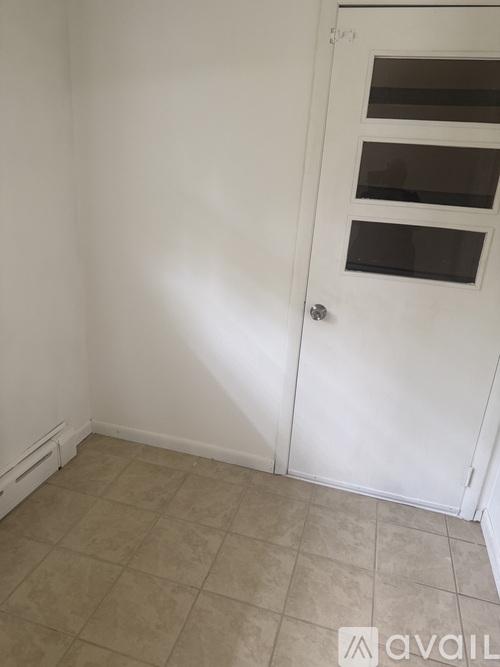 A white door with a glass panel is closed.