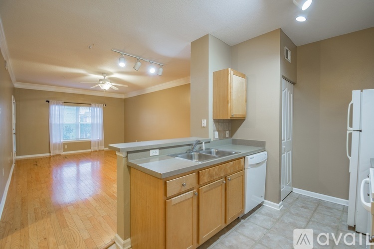 A kitchen with wooden cabinets and a white dishwasher.