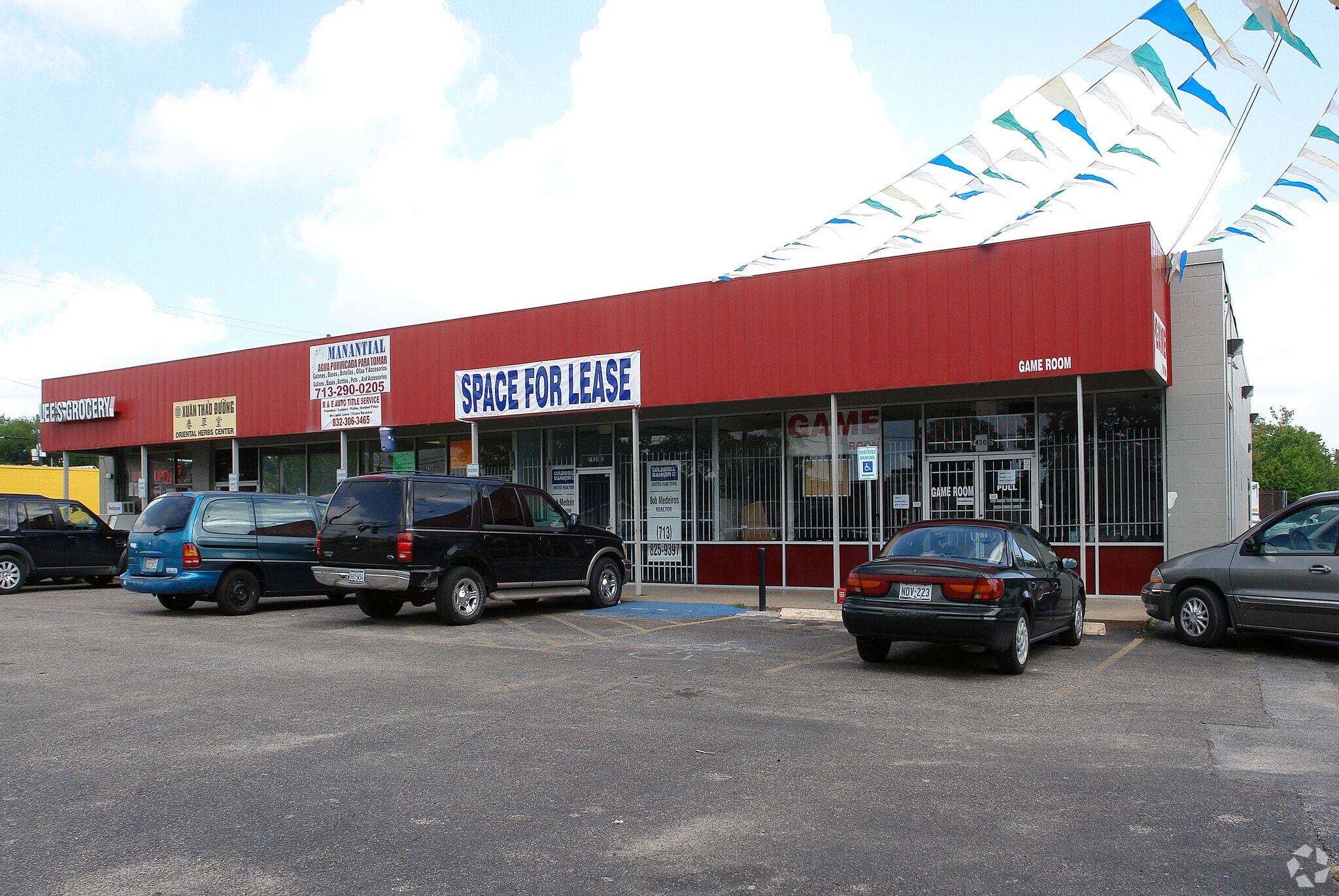 A red building with a sign that says "Space for Lease".