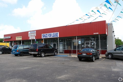 A red building with a sign that says "Space for Lease".