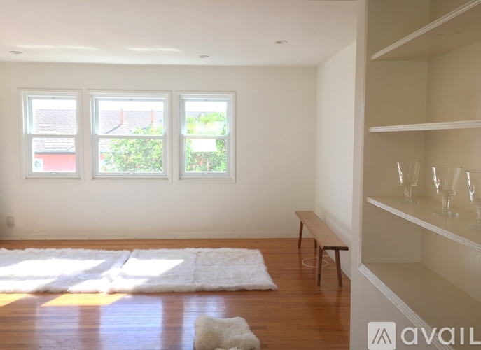A room with a bench and a window.