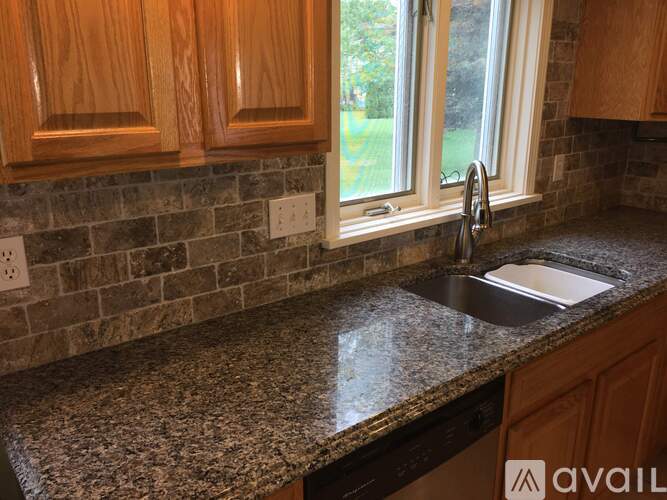 A kitchen counter with a sink and a window.