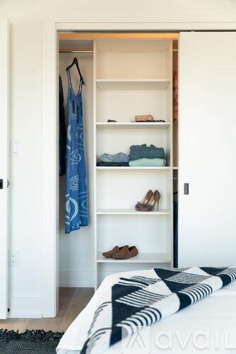 A bedroom with a bed, a wardrobe and a rug.