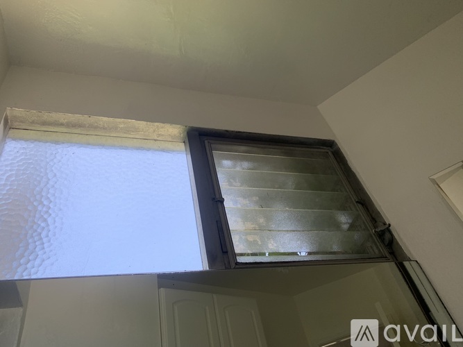 A window with a view of a cloudy sky.