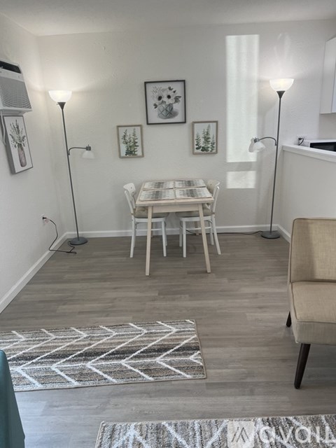 A dining room with a white table and chairs.