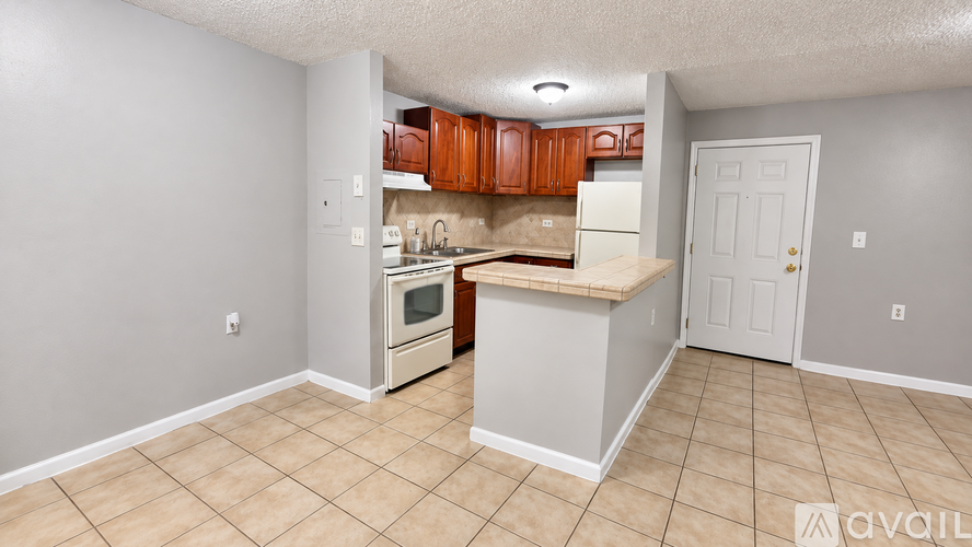 A kitchen with white cabinets and a white refrigerator.