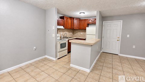 A kitchen with white cabinets and a white refrigerator.