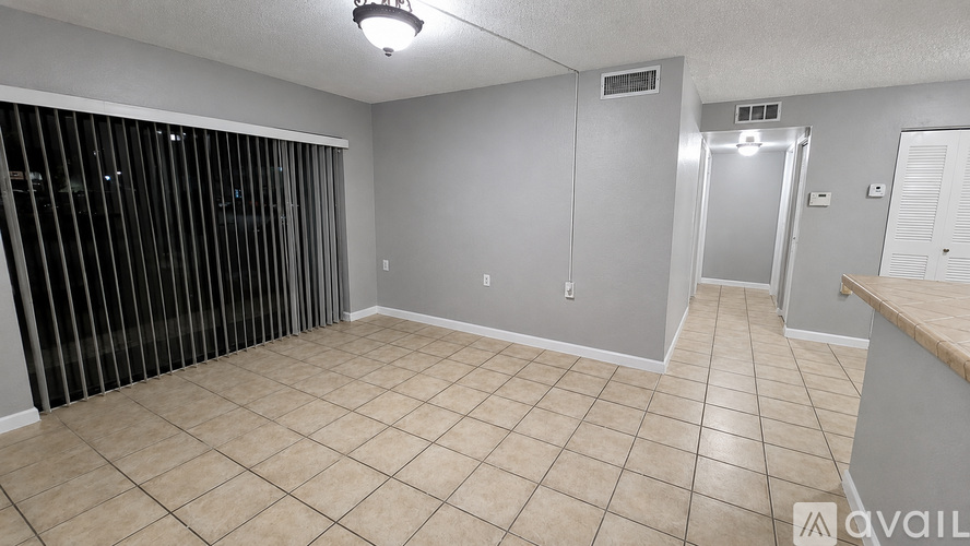 A room with a tiled floor and a sliding door.