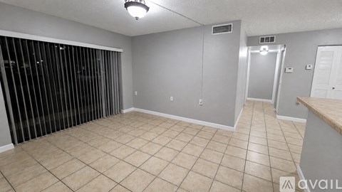 A room with a tiled floor and a sliding door.
