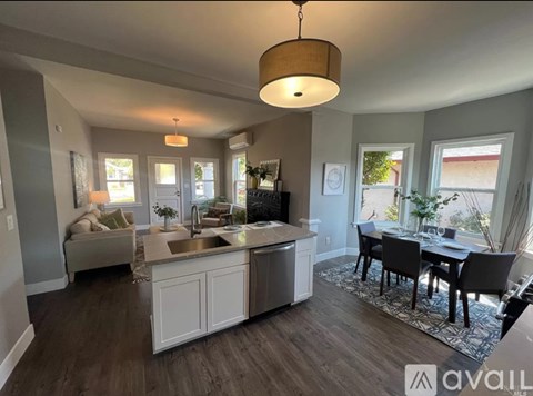 A modern kitchen with a dining table and chairs.