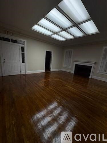A room with wooden floors and a skylight.