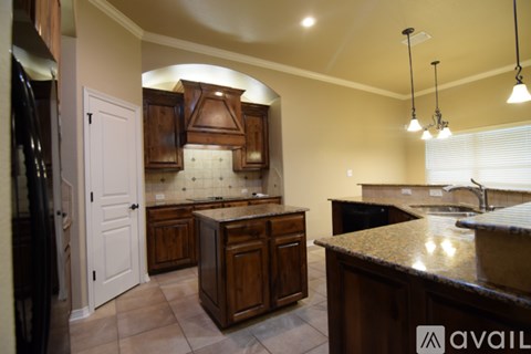 A kitchen with wooden cabinets and a granite countertop.