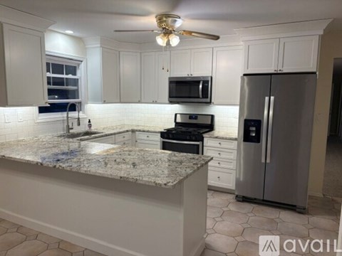A kitchen with granite countertops and stainless steel appliances.