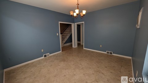 A room with blue walls and a wooden floor.