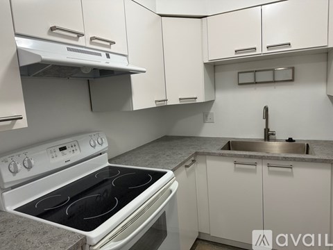 A white stove and sink in a kitchen.