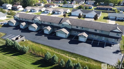 A large building with a parking lot in front of it.