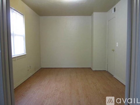 Empty room with wooden floor and white walls.