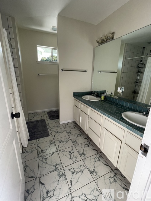 A bathroom with a white sink and a mirror.