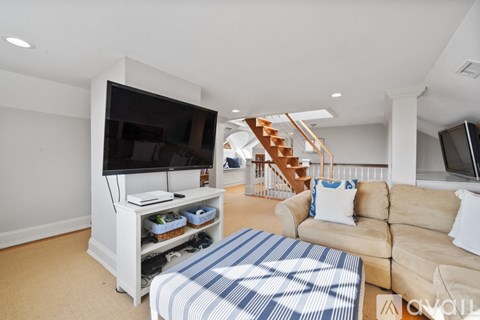 A living room with a television and a couch.