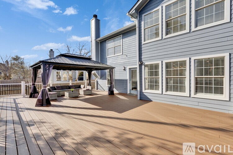 A house with a deck and a gazebo.