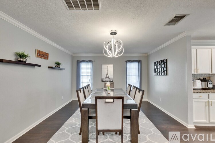 A dining room with a table set for four.