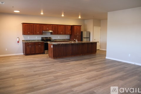 A kitchen with wooden cabinets and a countertop is available.