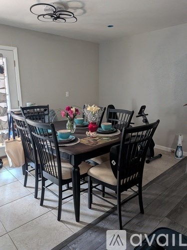 A dining room with a table set for six.