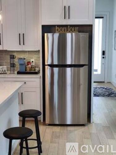 A stainless steel refrigerator with the brand name Bon Loup on it.