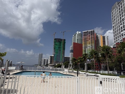 A pool area with a view of a city skyline.