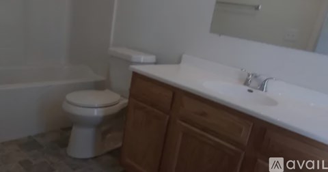 A white toilet sits next to a sink in a bathroom.