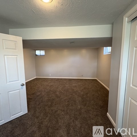A room with carpeted floor and white walls.