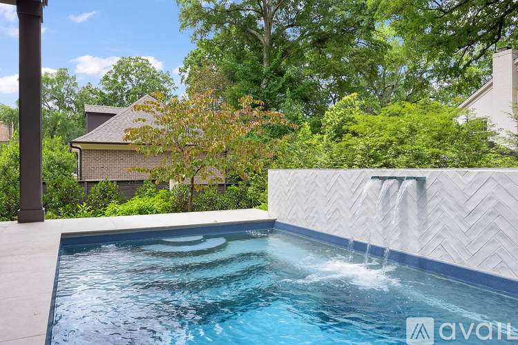 A pool with water flowing from a fountain in the middle.