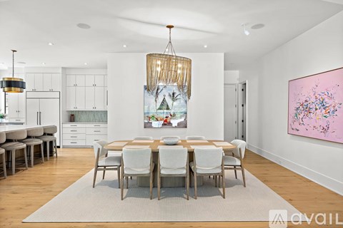 A modern dining room with a large table and chairs.