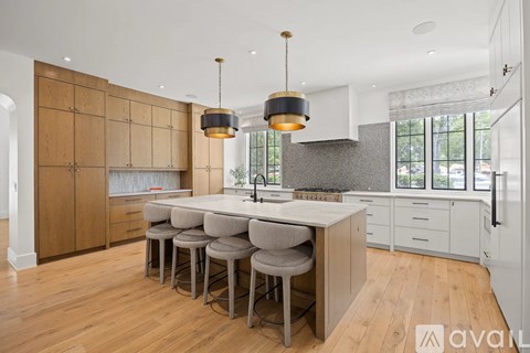 A modern kitchen with wooden cabinets and a central island.