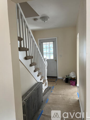 A room with a staircase and a door.