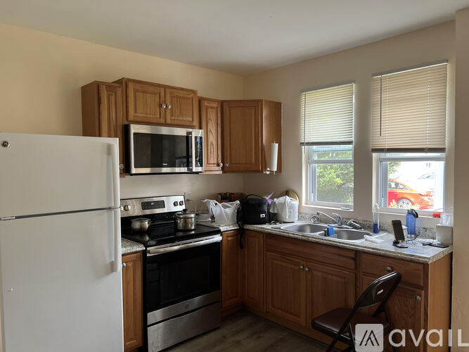 A kitchen with wooden cabinets and a white refrigerator.