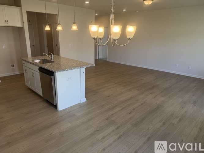 A kitchen with a sink, stove, and cabinets is available for rent.