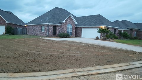 A house with a driveway in front of it is available for sale.