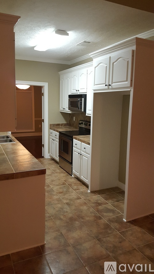 A kitchen with brown cabinets and a brown counter top.