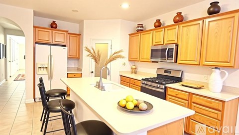 A kitchen with wooden cabinets and a white countertop.