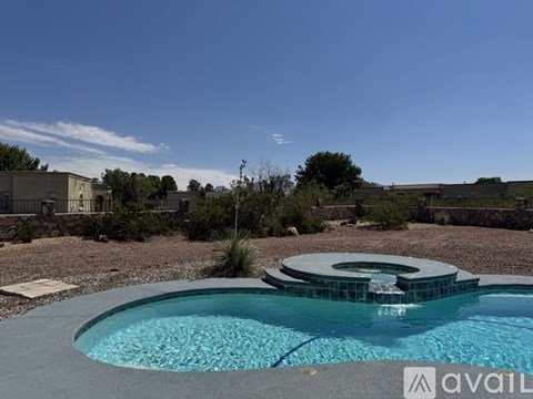 A pool with a hot tub in the middle of it.