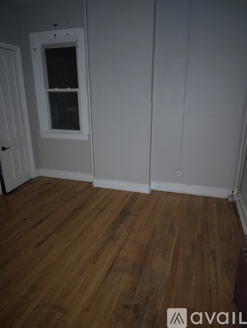 A room with wooden floors and white walls.