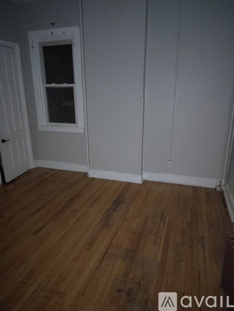 A room with wooden floors and white walls.